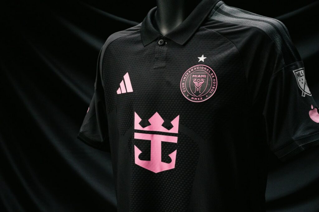 Close-up of Inter Miami black jersey with pink crest and sponsor logo