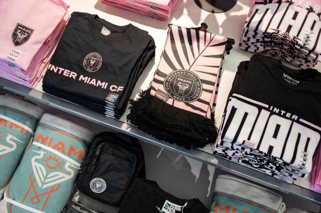 Inter Miami merchandise including shirts and scarf displayed in store
