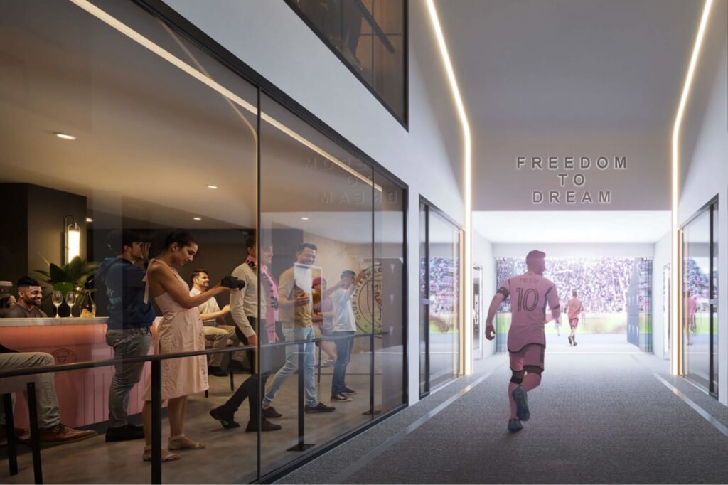 Player walking through stadium tunnel with “Freedom to Dream” sign overhead