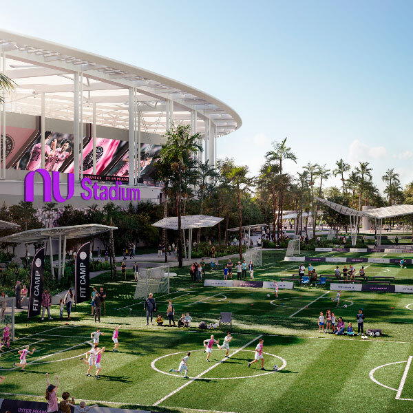 NU Stadium complex with outdoor soccer fields, children playing, and families gathered