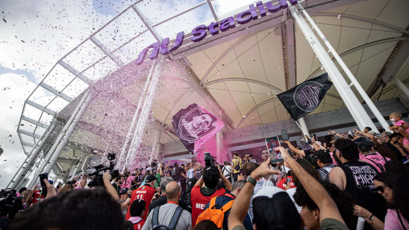 Fans gather outside Nu Stadium entrance as confetti falls during opening celebration