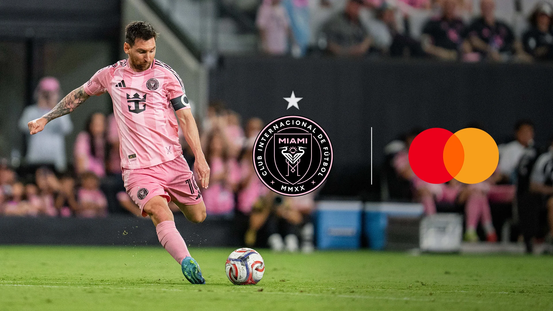 Lionel Messi playing soccer for Inter Miami CF during a match with club and Mastercard logos displayed.
