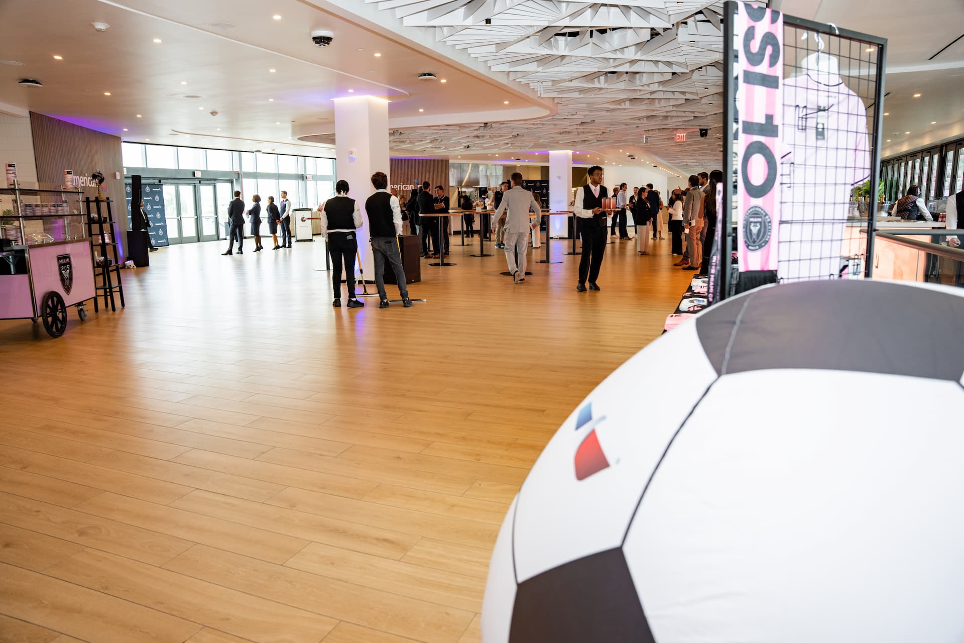 Guests gather inside the American Airlines Lounge at NU Stadium, featuring Inter Miami CF displays and modern event spaces.