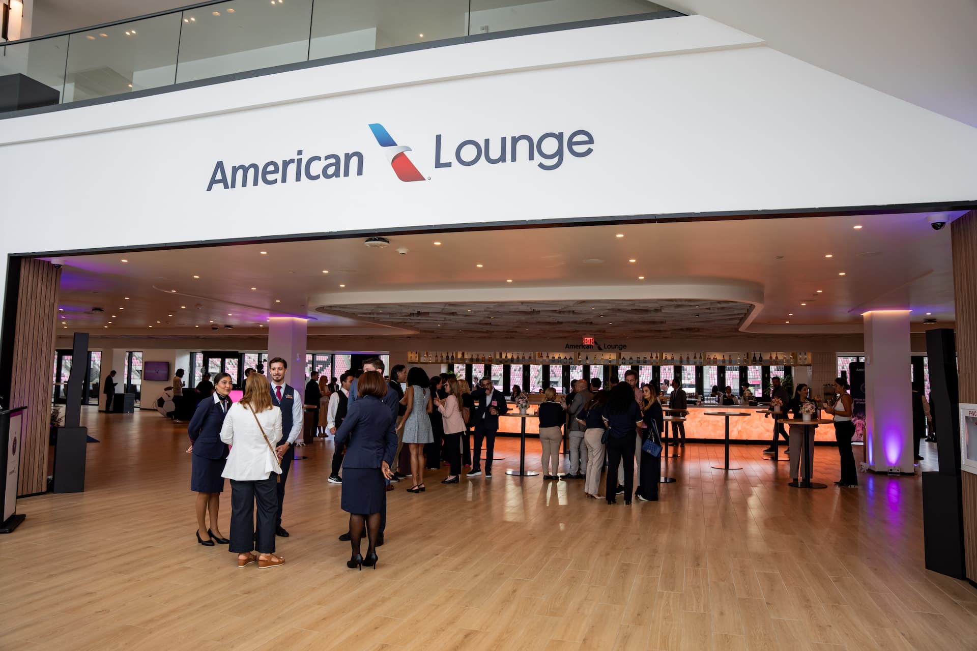 American Airlines Lounge at Inter Miami CF's NU Stadium featuring guests socializing near the bar and hospitality area.